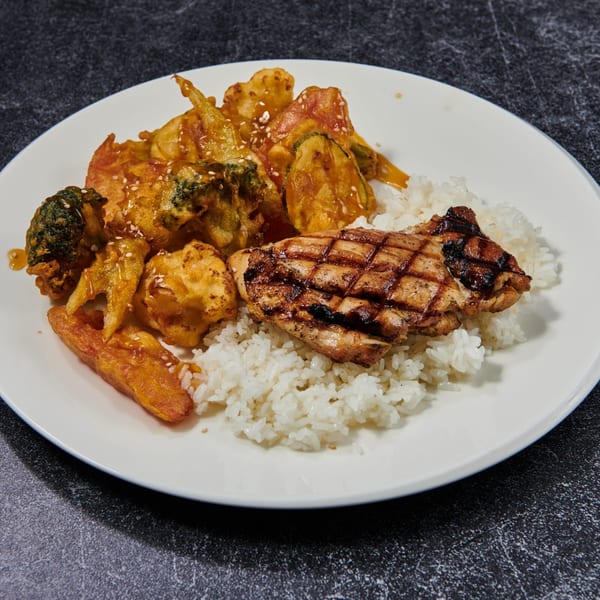 Grilled chicken and tempura vegetables with rice on a white plate.