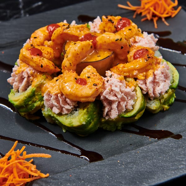 El Sushi Loco's avocado and tuna sushi rolls topped with spicy shrimp and sauce.
