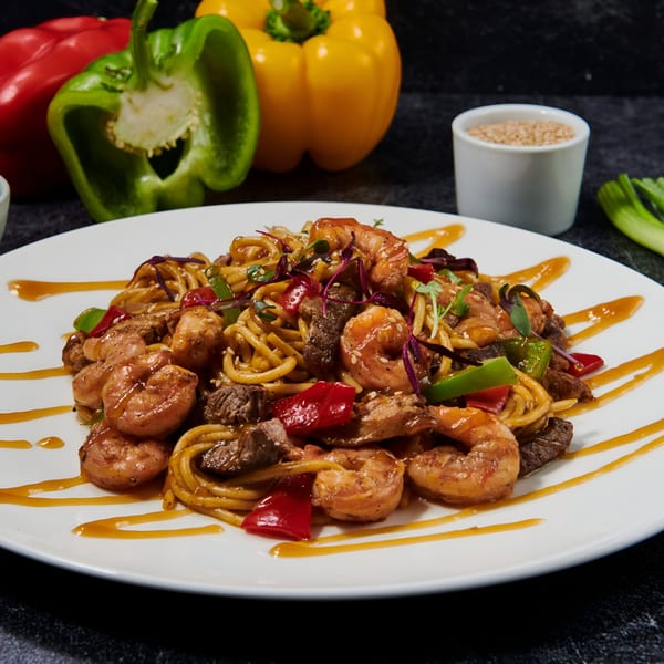 El Sushi Loco's shrimp and beef stir-fry noodles with bell peppers and sauce.