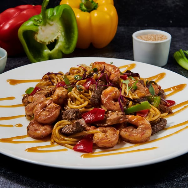El Sushi Loco's shrimp and beef stir-fry noodles with bell peppers and sesame seeds.